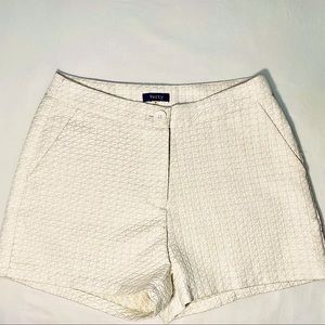 Verty cream and gold shorts.